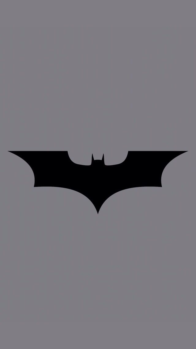 the dark knight batman logo on a gray background