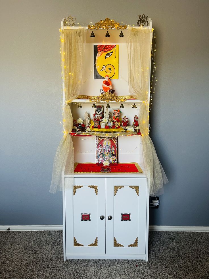 an old fashioned toy kitchen with lights on the top and doors open to show what's inside