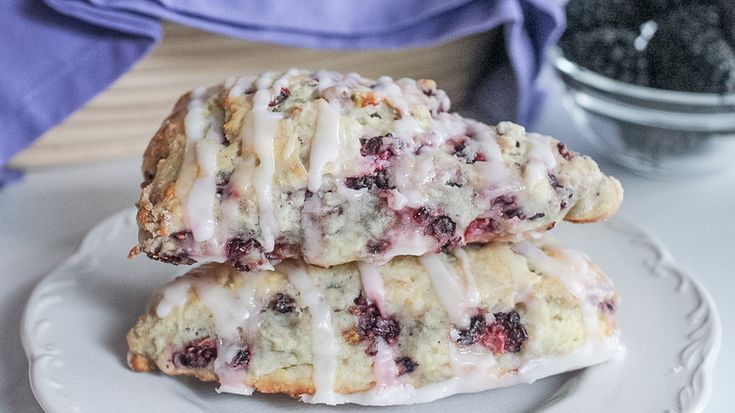 two blueberry scones on a white plate