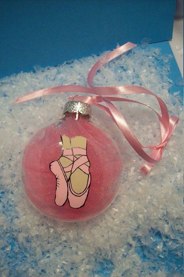 a pink ornament with a hand drawn figure on it's side in snow