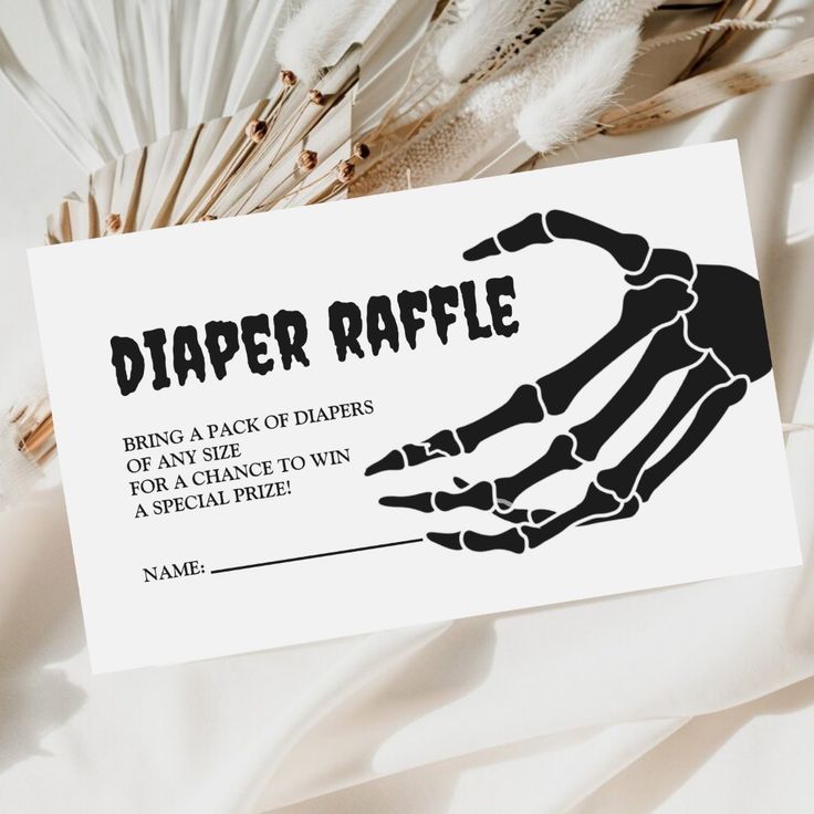 a paper raffle card with a skeleton hand on it and the words, diaper raffle