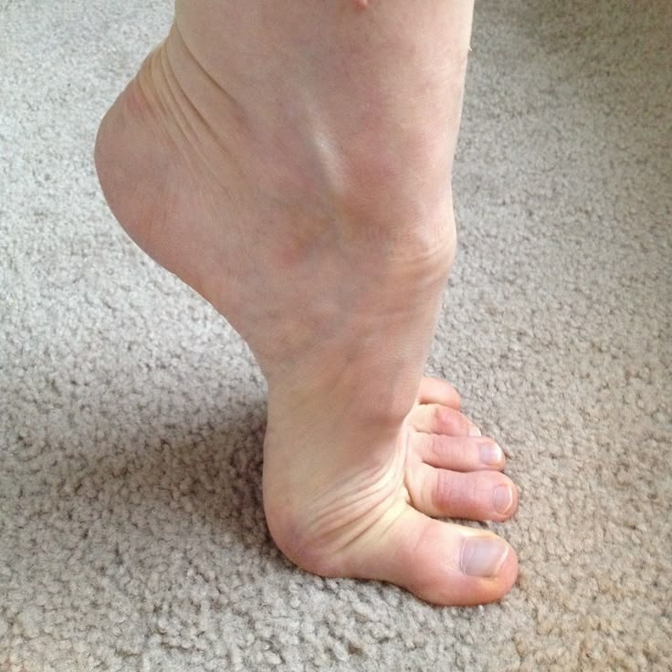 a close up of a person's bare feet on the carpet