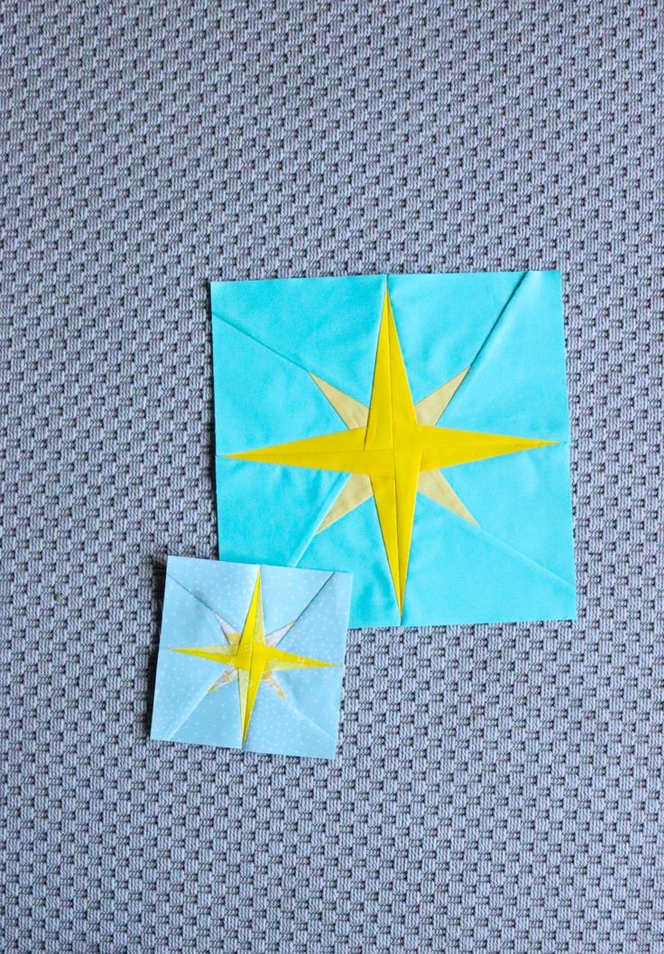 two pieces of paper with yellow and blue stars on them sitting next to each other