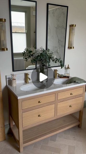 a bathroom with two sinks and mirrors in it