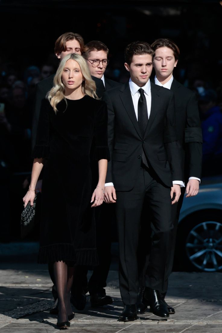 two men and a woman walking down the street