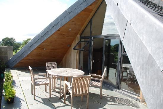 a table and chairs on a patio under a roof