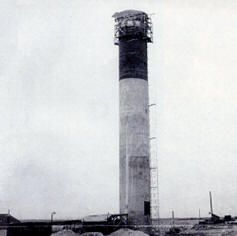 an old black and white photo of a large tower