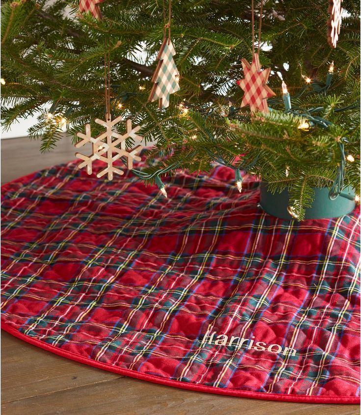 a christmas tree skirt with snowflakes hanging from it