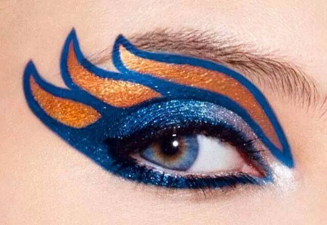 a woman's eye with blue and orange makeup