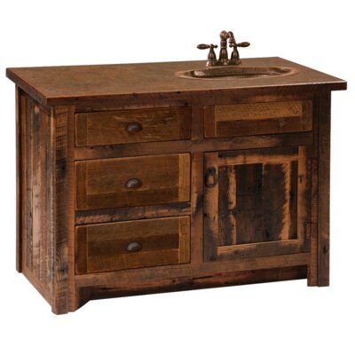 an old wooden sink cabinet with two drawers and a faucet on the top