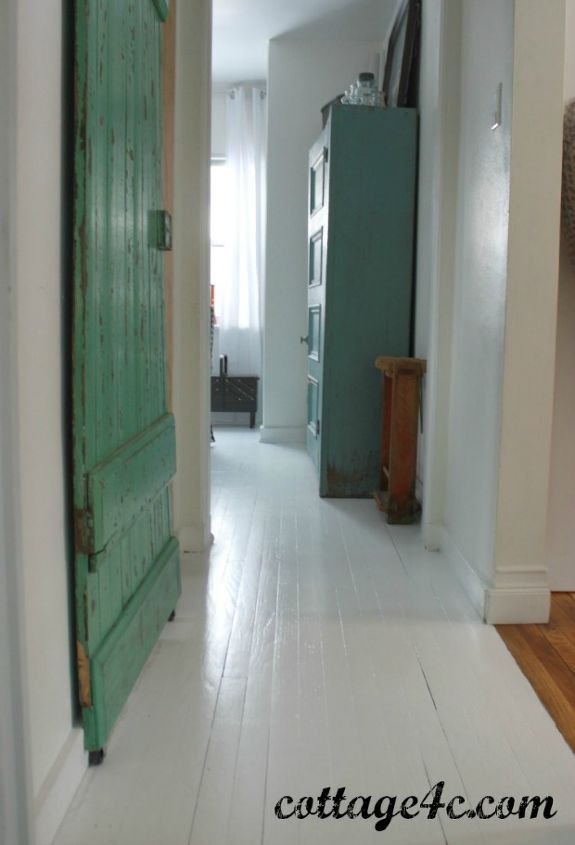 an open green door in a white hallway