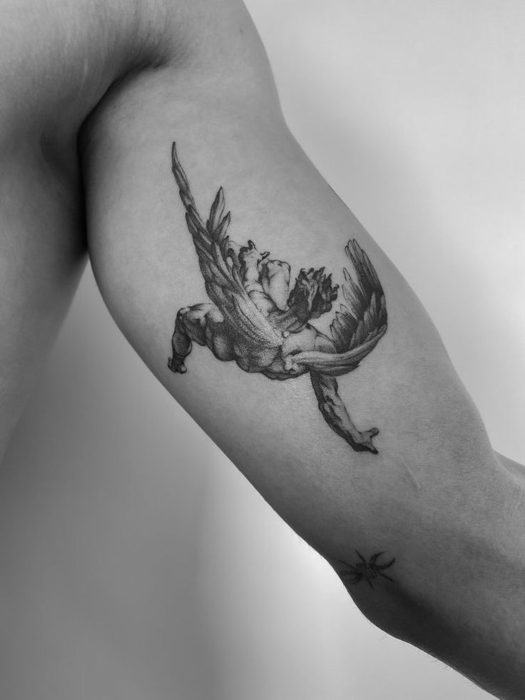 a man's arm with a bird tattoo on it