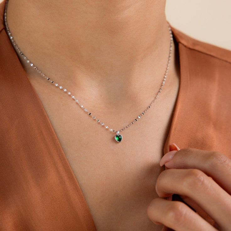 Presenting our delicate, Tiny Jade Heart Necklace, designed to bring a touch of love and serenity to your everyday look. Paired with a sleek mirror chain, this necklace adds a touch of balance and sophistication to any outfit, making it the perfect accessory for everyday wear ♡ SKU: RR-NR193 Product Details Material: High Quality Solid 925 Sterling Silver Finish: Sterling Silver ∙ 18K Gold Featuring a tiny ~5.5 x 5.5mm Jade CZ Gemstone Heart Charm on a Mirror Chain, adjustable from 16 to 18 inch Elegant Heart Pendant Chain Necklace, Elegant Heart Pendant Chain Necklace With Delicate Chain, Elegant Birthstone Necklace As A Gift, Elegant Birthstone Necklace Gift, Elegant Heart-shaped Chain Necklace As Gift, Elegant Heart-shaped Chain Necklace Gift, Silver Necklace With Delicate Chain For May Birthstone, Elegant Heart Shaped Chain Necklace For Gift, Elegant Heart Necklace For May Birthstone