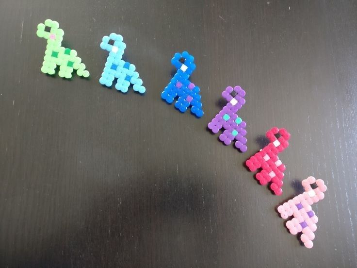 four different colored beads sitting on top of a black surface next to eachother