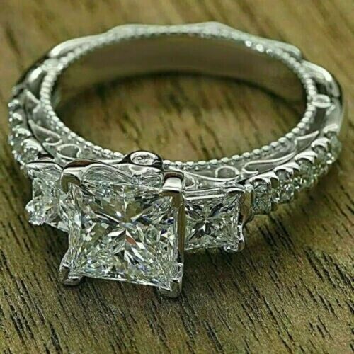 an engagement ring with three princess cut diamonds