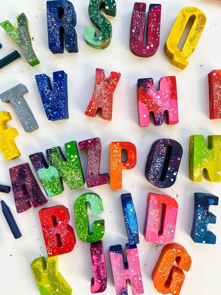 the letters are made up of different types of glitters and sparkle dust on top of each other