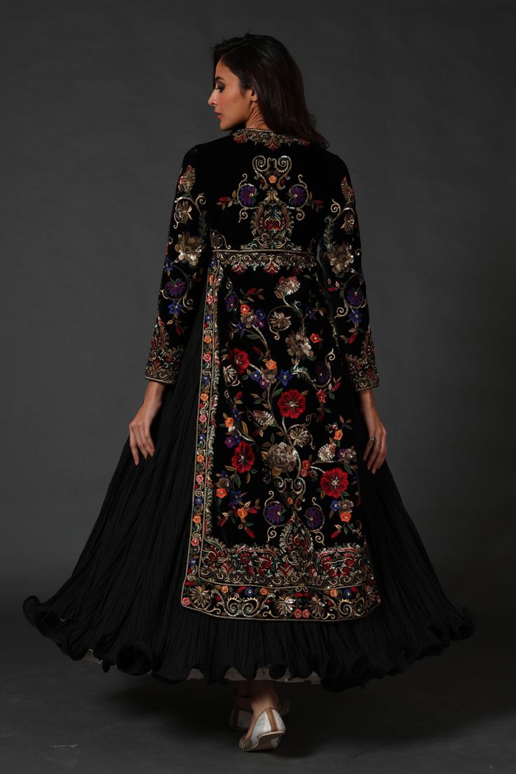 Editor's Note Black Silk Velvet Split Anarkali, Attached Crinkled Ghera Comes With Dupatta & Churidar Color: Black Fabric: Silk Velvet & Cotton Care: Dry Clean Only About the Designer Rohit Bal is intensely concerned with design as an art form. The designer draws on history, fantasy and folklore to create masterpieces that are desired by discerning aficionados around the globe. Rohit has a deep understanding of the psyche of the fashion world and it reflects in his collections that are intellige Velvet Anarkali, Black Anarkali, Long Jackets For Women, Embroidered Anarkali, Velvet Dress Designs, Rohit Bal, Dresses Indian, Pakistani Bridal, Designer Dresses Indian