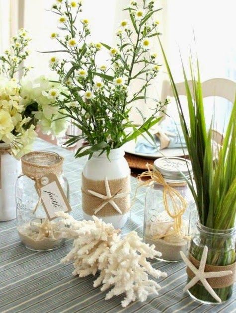 vases filled with flowers sitting on top of a table