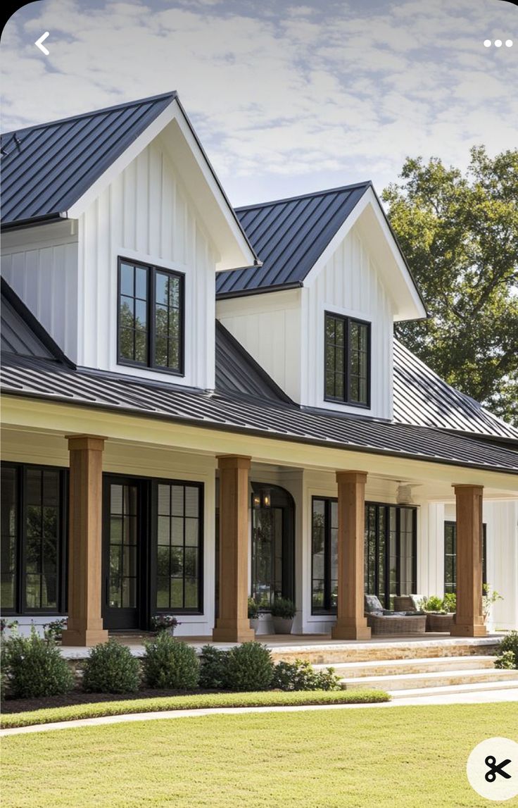 a large white house with lots of windows and black shutters on it's sides