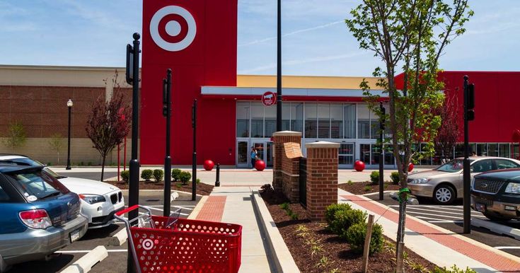 an empty shopping cart in front of a target store with cars parked outside the building