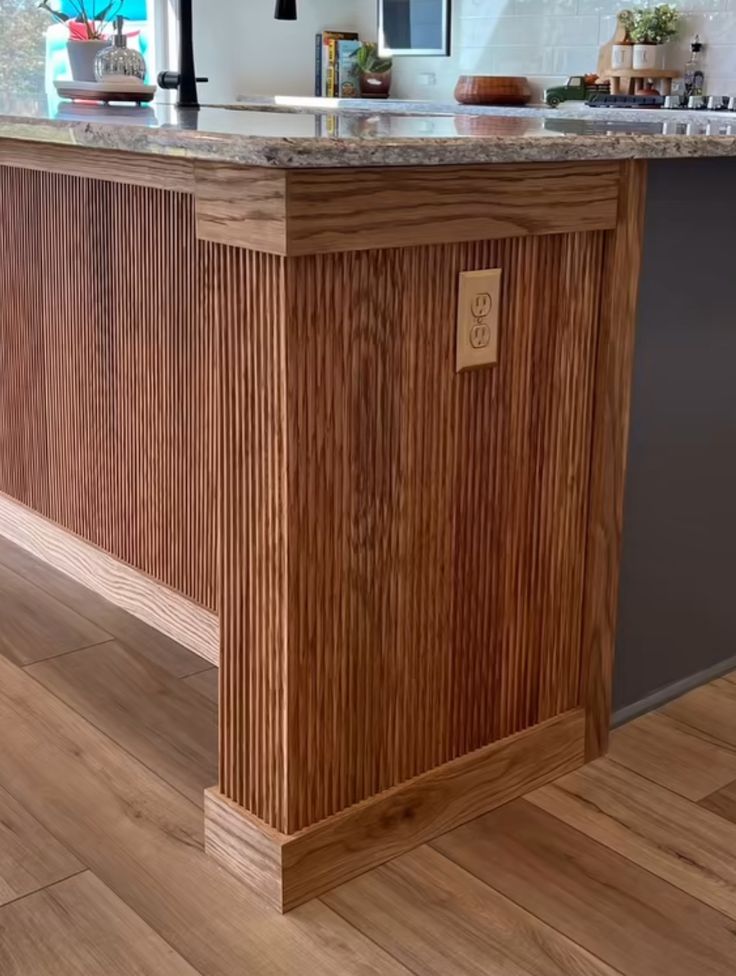 a kitchen with an island made out of wood