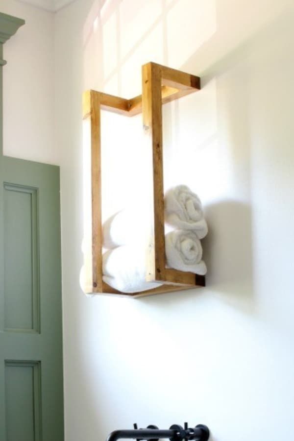 a bathroom with a sink, mirror and towel rack