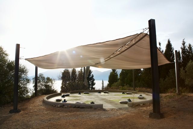 the sun shines brightly on an outdoor area with rocks and trees in the background