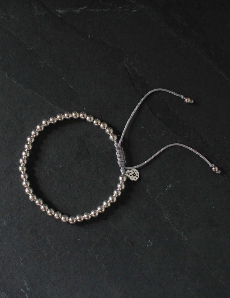 Crafted with tarnish-resistant sterling silver beads, this versatile piece is elegant yet perfect for everyday wear. Its adjustable design ensures a perfect fit for any wrist, making it a must-have addition to any collection. Macramé style bracelet Sterling Silver Beads Thread Color: Silver Adjustable from 3-5 inches in diameter 100% handmade, therefore slight variations may occur Classic Hand-strung Sterling Silver Bracelets, Classic Sterling Silver Bracelets With Silver Beads, Classic Adjustable Sterling Silver Bracelet For Everyday, Classic Silver Hand-strung Bracelet, Classic Hand-strung Silver Bracelets, Elegant Adjustable Beaded Bracelets For Everyday, Adjustable Elegant Beaded Bracelet For Everyday, Classic Adjustable Beaded Bracelets With Silver Beads, Adjustable Round Sterling Silver Bracelet For Gifts