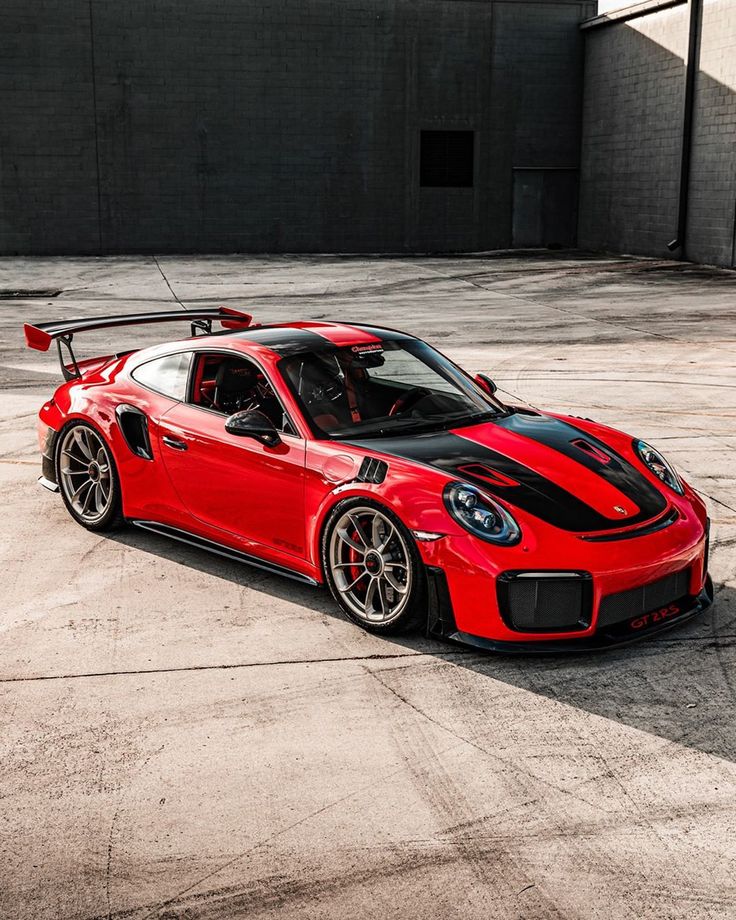 a red sports car parked in an empty parking lot