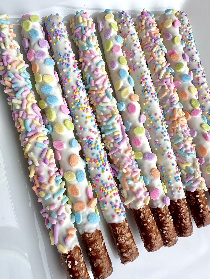 there are many candy sticks with sprinkles on them