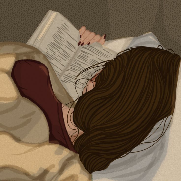 a woman laying in bed reading a book with her head on top of the pillow