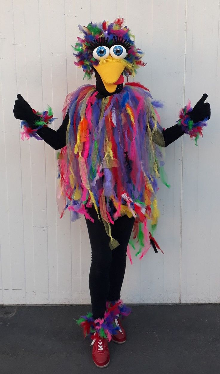 a person dressed up as a bird with feathers on it's head and arms