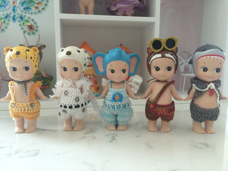 a group of little dolls standing next to each other