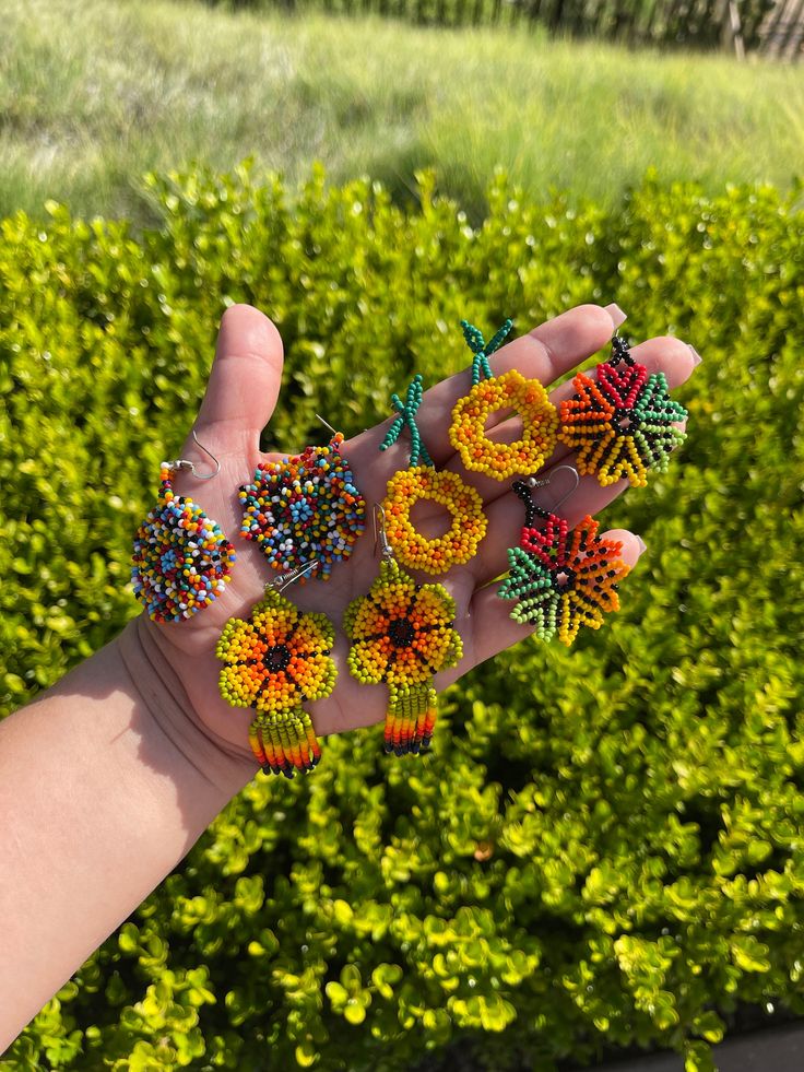 Handmade earrings by the Wayuu tribe of Colombia, unique pieces made with a lot of dedication and love. Unique Adjustable Beaded Earrings With Dangling Beads, Beaded Flower Dangle Earrings For Festivals, Artisan Beaded Earrings With Round Beads For Festivals, Colorful Beads Drop Earrings For Festivals, Colorful Beaded Flower Earrings For Gift, Traditional Dangle Beaded Earrings As Gift, Unique Adjustable Beaded Drop Earrings, Artisan Earrings With Colorful Beads And Adjustable Fit, Artisan Adjustable Earrings With Colorful Beads