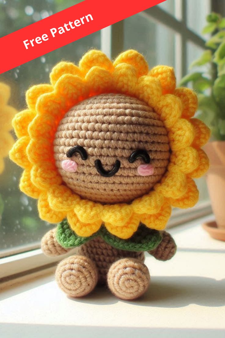 a small crocheted sunflower sitting on top of a window sill next to a potted plant