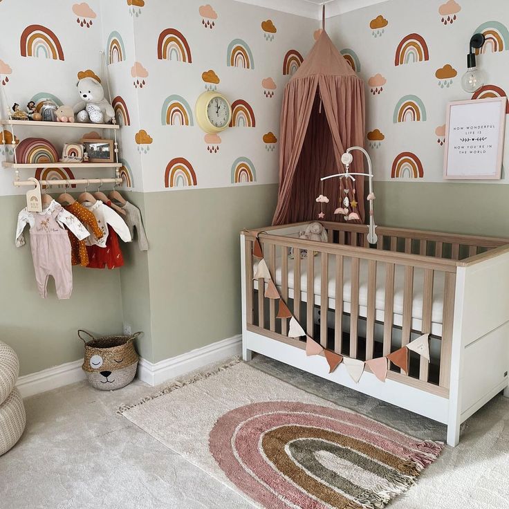 a baby's room with a crib and rainbow wallpaper