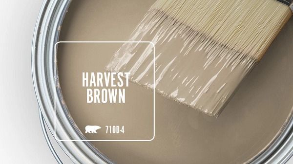 a paint can with a brush in it and the words harvest brown painted on it