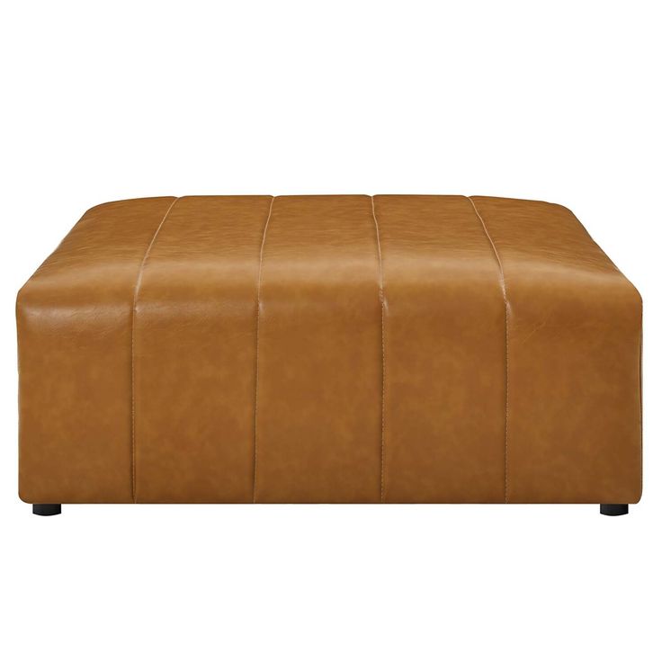 a tan leather ottoman with black legs