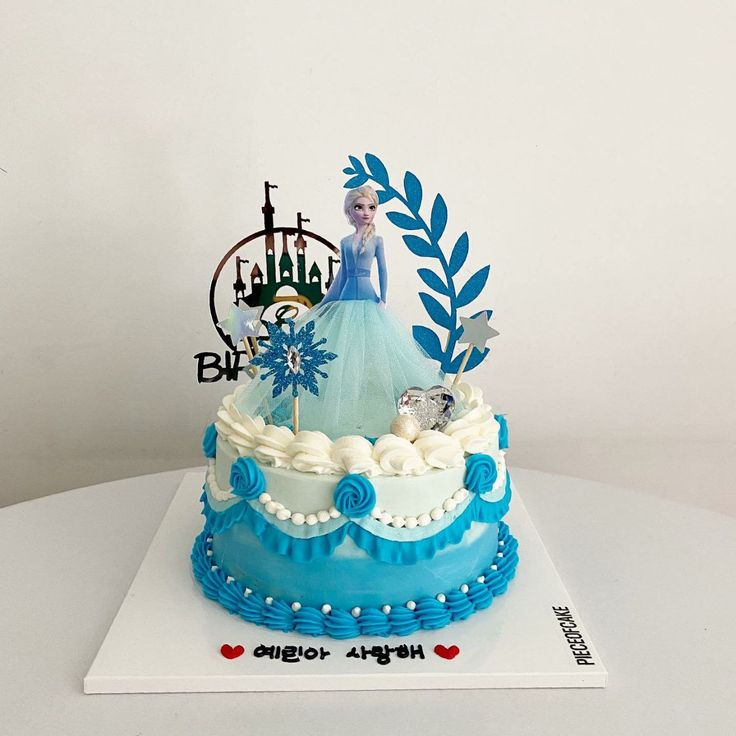 a frozen princess cake with blue frosting and decorations