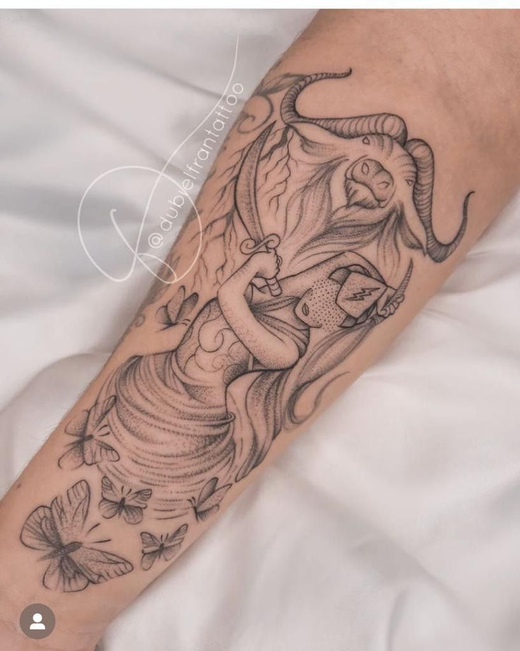 a person with a tattoo on their arm and an animal in the middle of it