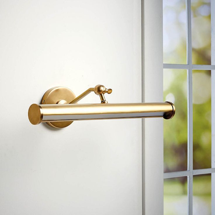 a door handle on the side of a white door with windows in the back ground