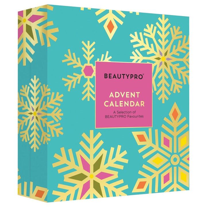 the beauty pro calendar is on display in front of a blue background with gold snowflakes