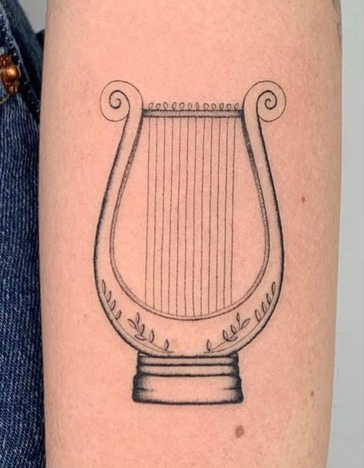 a black and white drawing of a harp on the arm