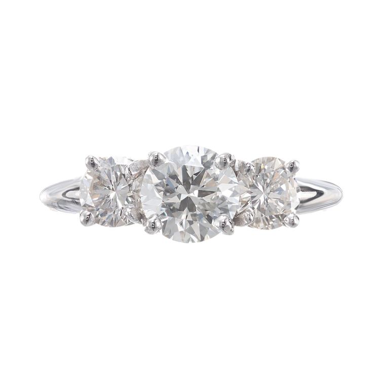 three stone diamond ring in white gold with diamonds on the sides and an oval setting