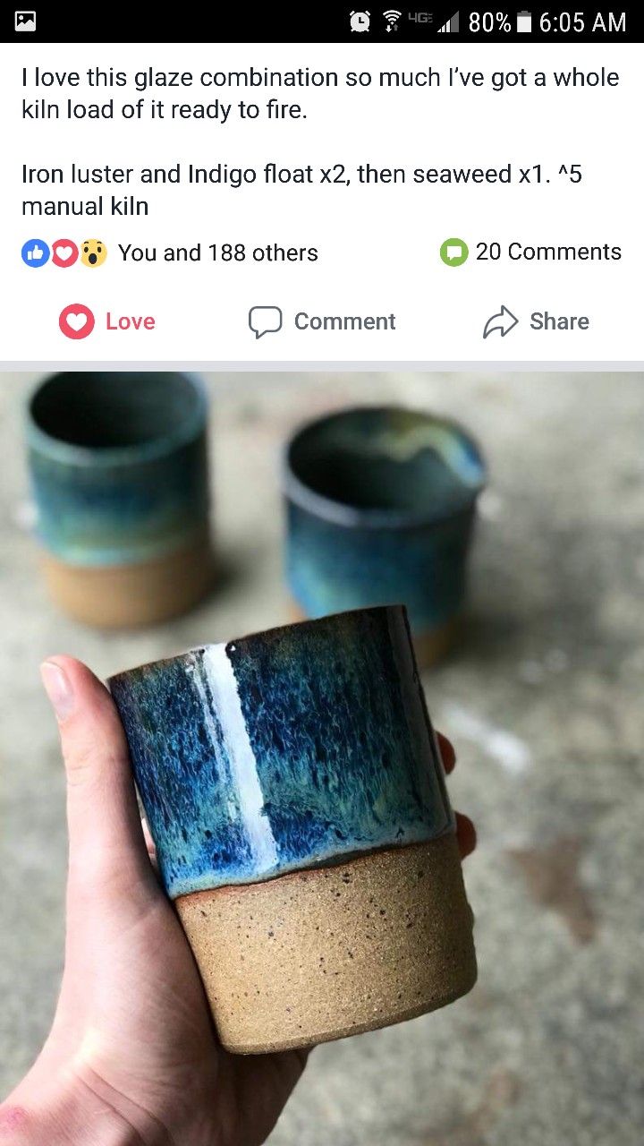 someone is holding up a cup that looks like it has been made from ceramic pottery