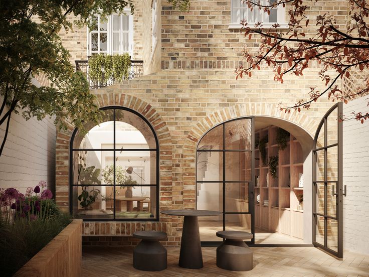 an outdoor area with brick walls and arched windows