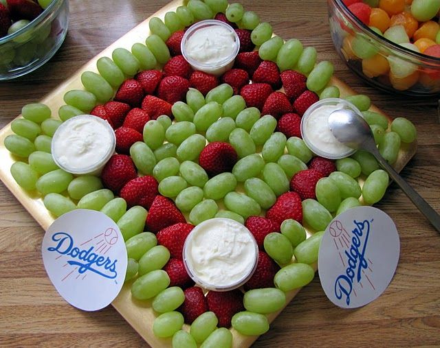 grapes and strawberries arranged in the shape of a heart with yogurt on top