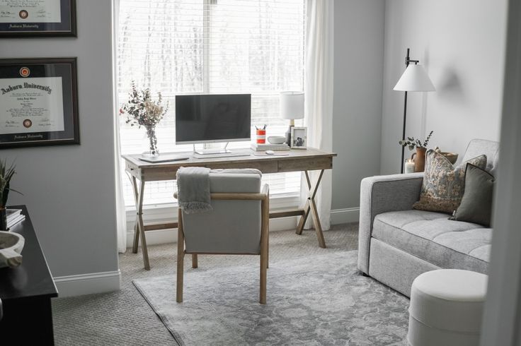 a living room filled with furniture and a flat screen tv on top of a wooden desk