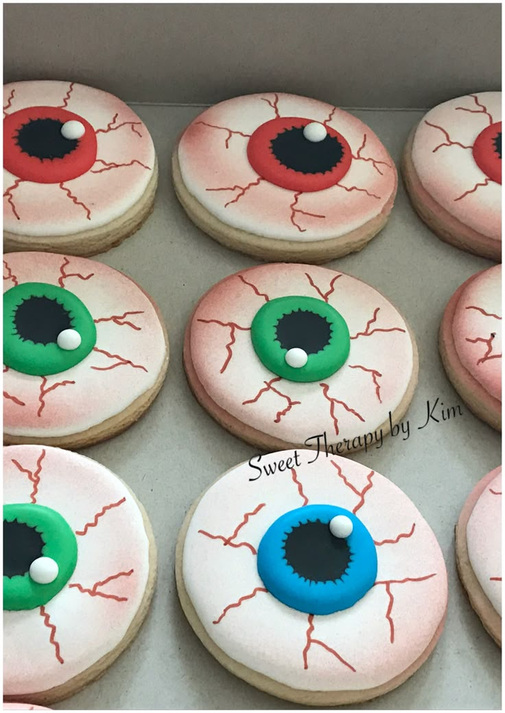 decorated cookies in the shape of eyeballs are ready to be eaten for halloween party