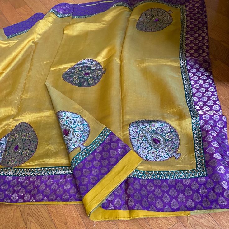 Shiny Silk Blend Yellow Saree With Purple Border Shiny And Nice Appliqu Work With Nice Contrast Colors Love It But Have Too Many Of Same Color And I Like Simple Stuff. Ask For Pit To Pit Measurements Of Blouse 17.5 So 35. Most Of My Blouses Have Some Extra Cloth To Adjust The Size. I Can Take Pictures If That Too The Blouse Is The Purple Like The Border I Had Extra Purple So I Put It For This Saree. Purple Border, Yellow Saree, Take Pictures, The Purple, Contrasting Colors, Blouses, Saree, Womens Sizes, Silk